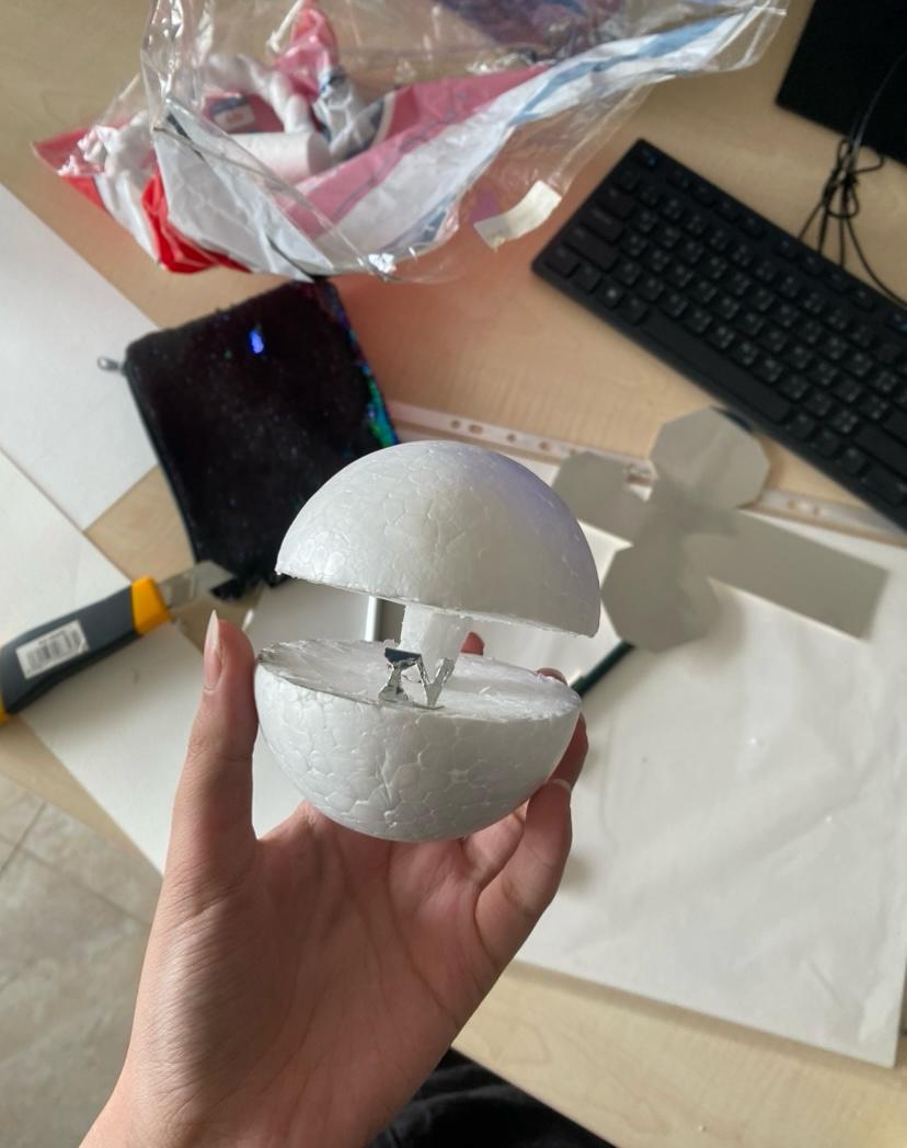 Foam Orbit prototype on a desk next to cutting tools and templates