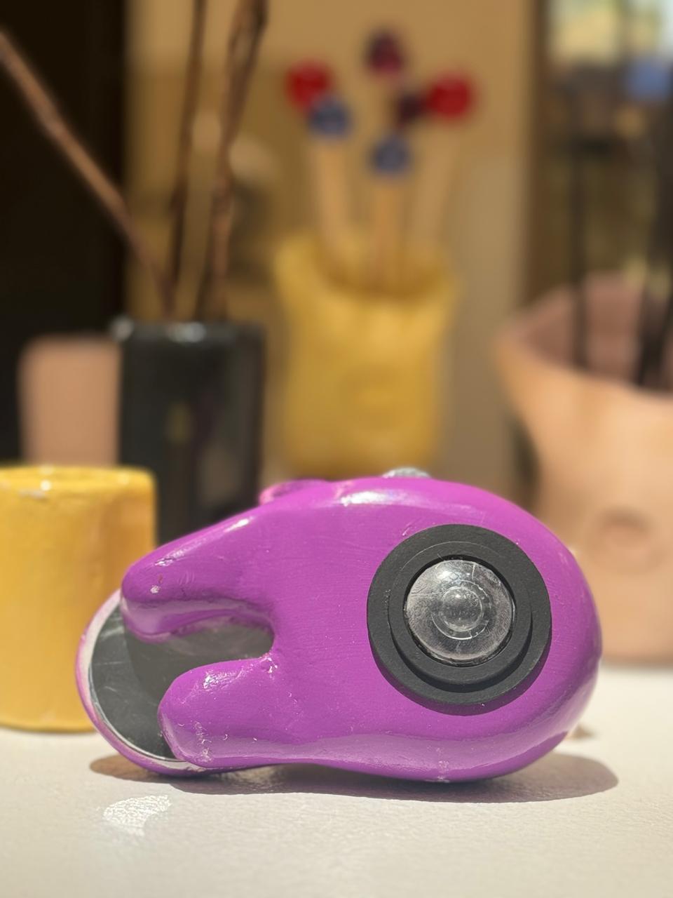 MIRAA final prototype side view on a white surface, lens housing visible