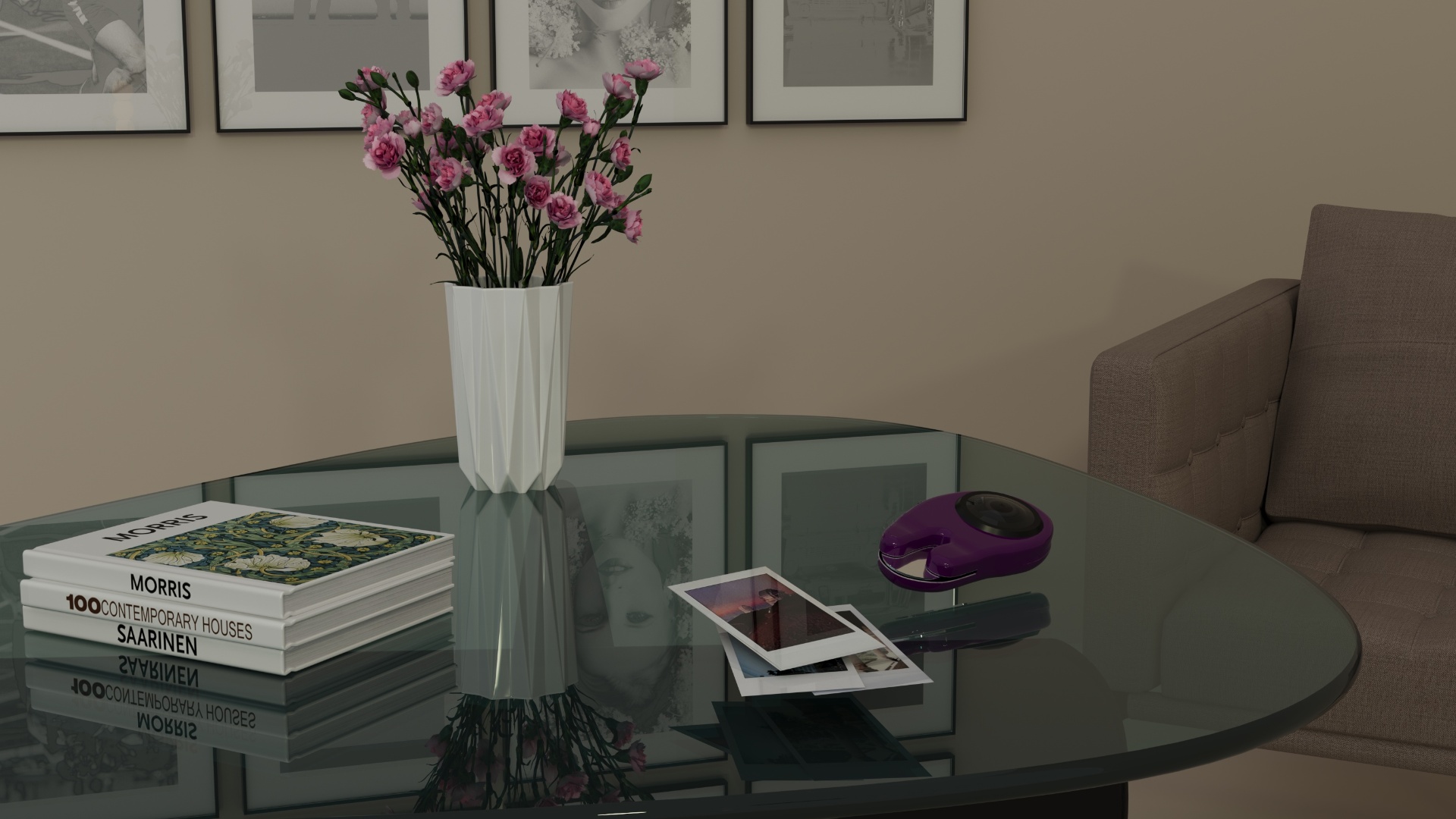 MIRAA pocket camera in a lifestyle scene, resting on a glass coffee table next to instant photos, design books and a vase of pink carnations